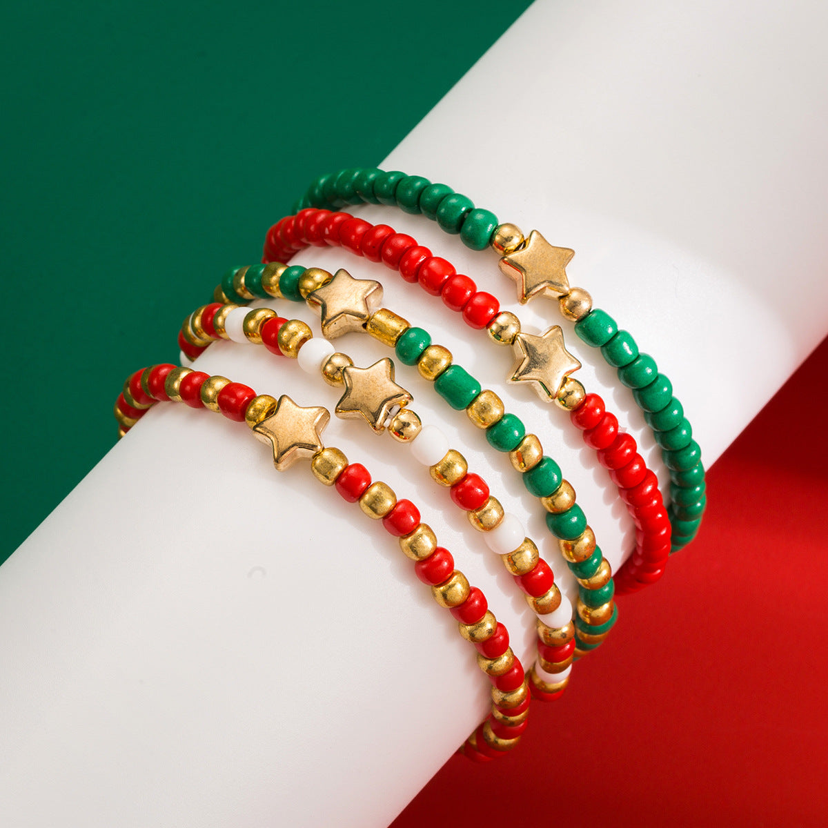 Pulsera apilable de estrella geométrica con cuentas pequeñas verdes y rojas y detalles CCB para mujer