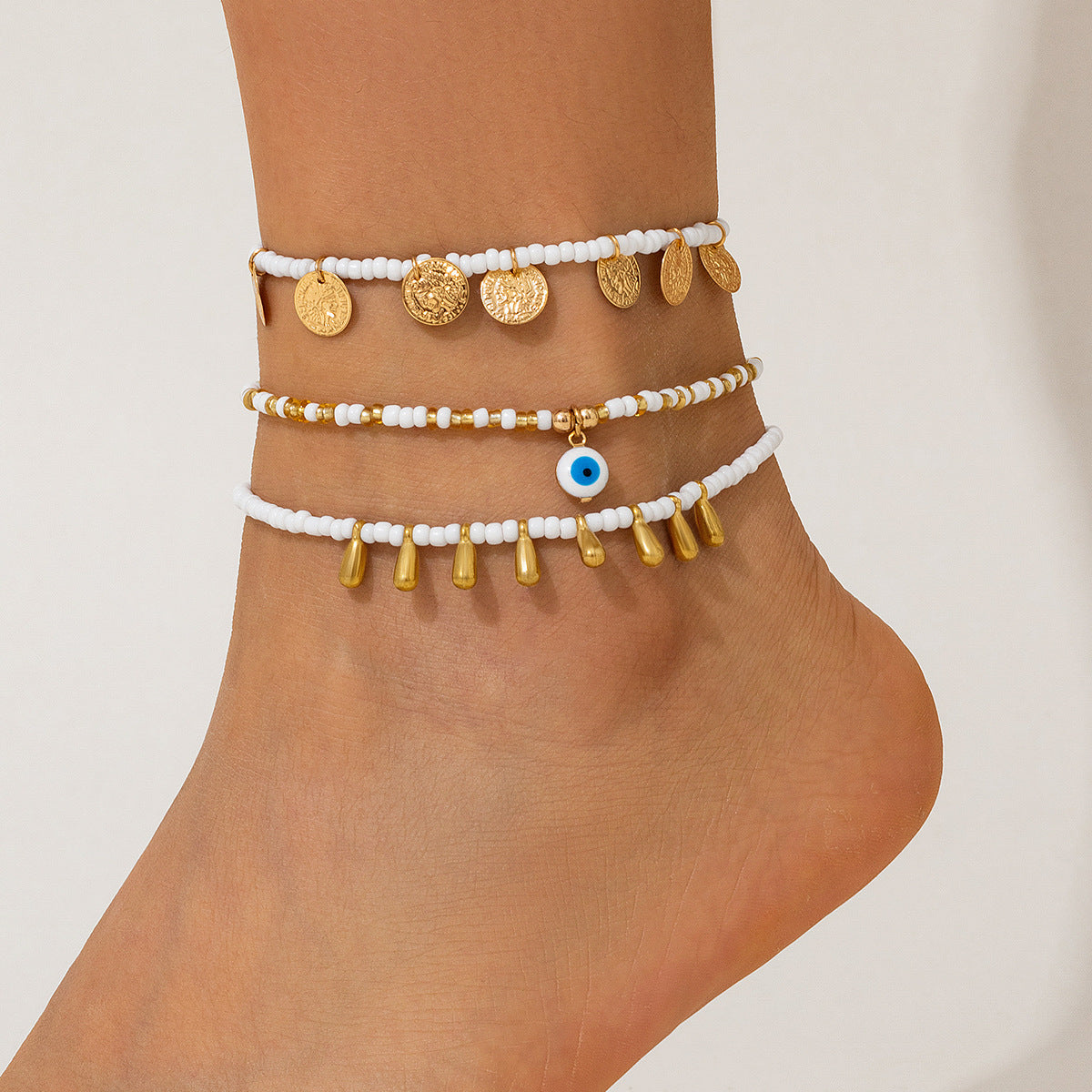 Tobillera geométrica de aleación con inspiración étnica marina, con colgantes de disco y gota, y detalle de borla para mujer