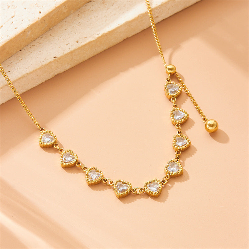 Minimalist Plated Stainless Steel Heart Pendant Necklace with Rhinestone Accents and Long Tassel Chain