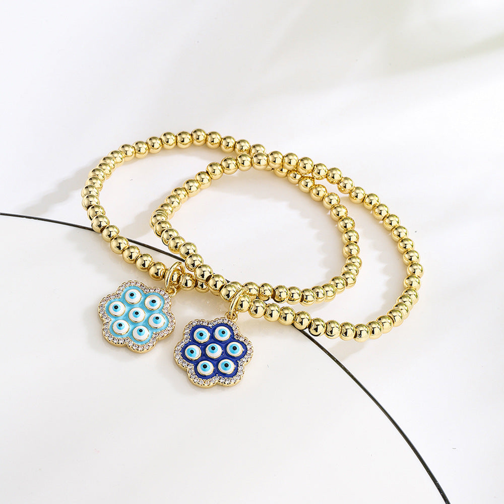 Bracciale geometrico in rame stile INS con placcatura in oro 18K, intarsio di strass e dettaglio occhio blu smaltato