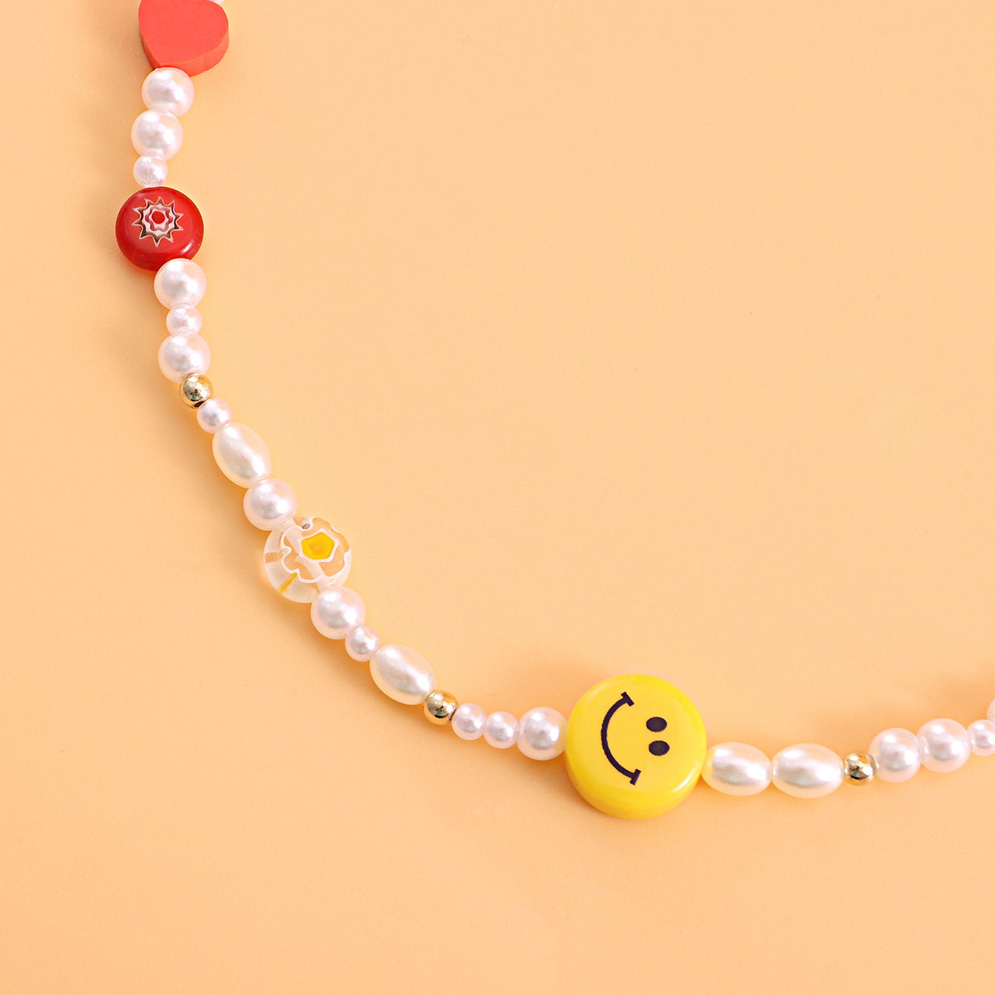 Yellow Smiley Face Acrylic Necklace with Red Heart-Shaped Polymer Clay and Glass Flower Pendant on Clear Fishing Line Chain