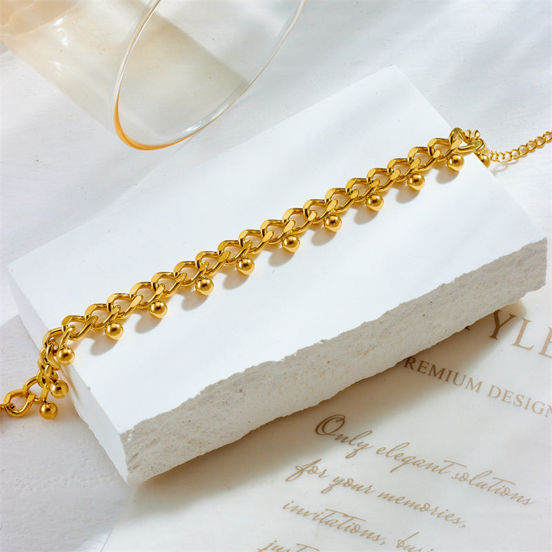 Bracciale da donna stile minimalista retrò con nappine a sfera in acciaio al titanio e finitura galvanizzata