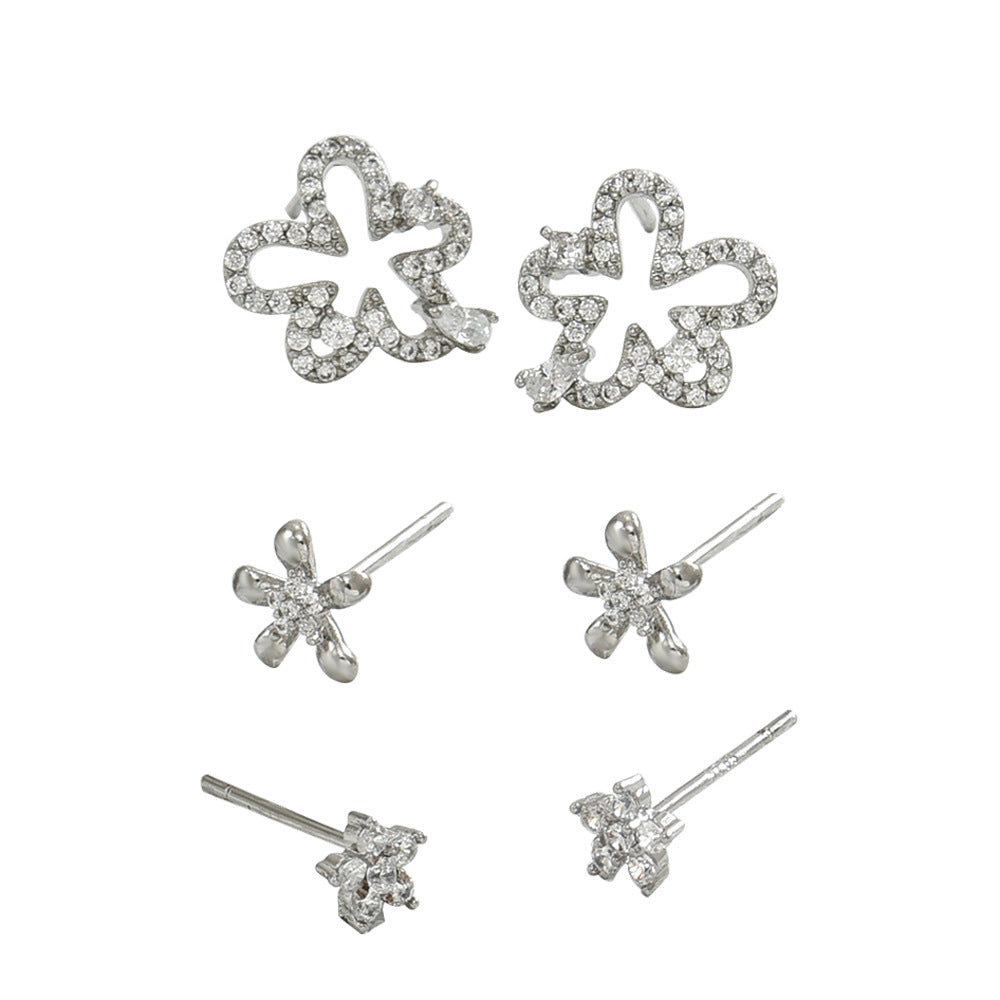 Juego de pendientes minimalistas de flor geométrica para mujer con incrustaciones de circonita sobre base de cobre y postes de acero inoxidable