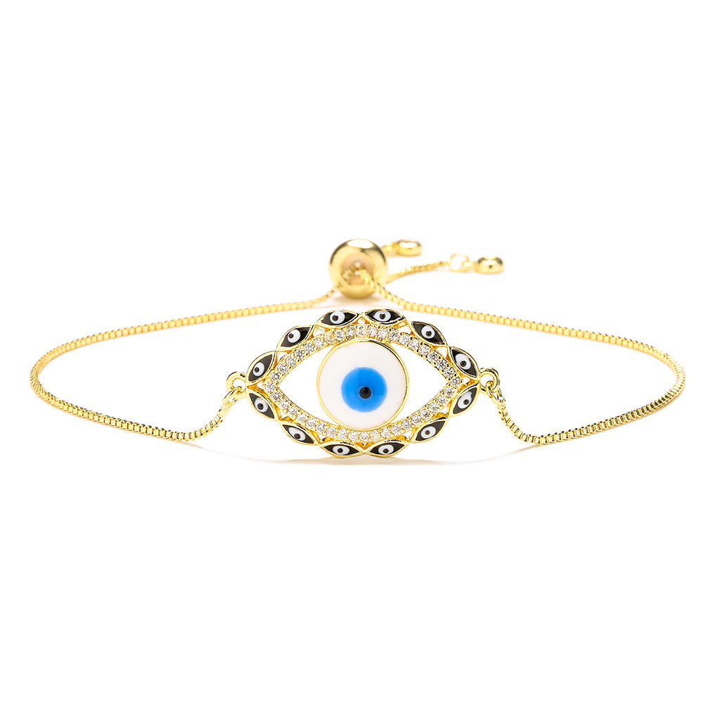 Bracciale da donna stile bohémien con charm a forma di occhio di Nazar, base in rame placcata in vero oro e intarsio di zirconi