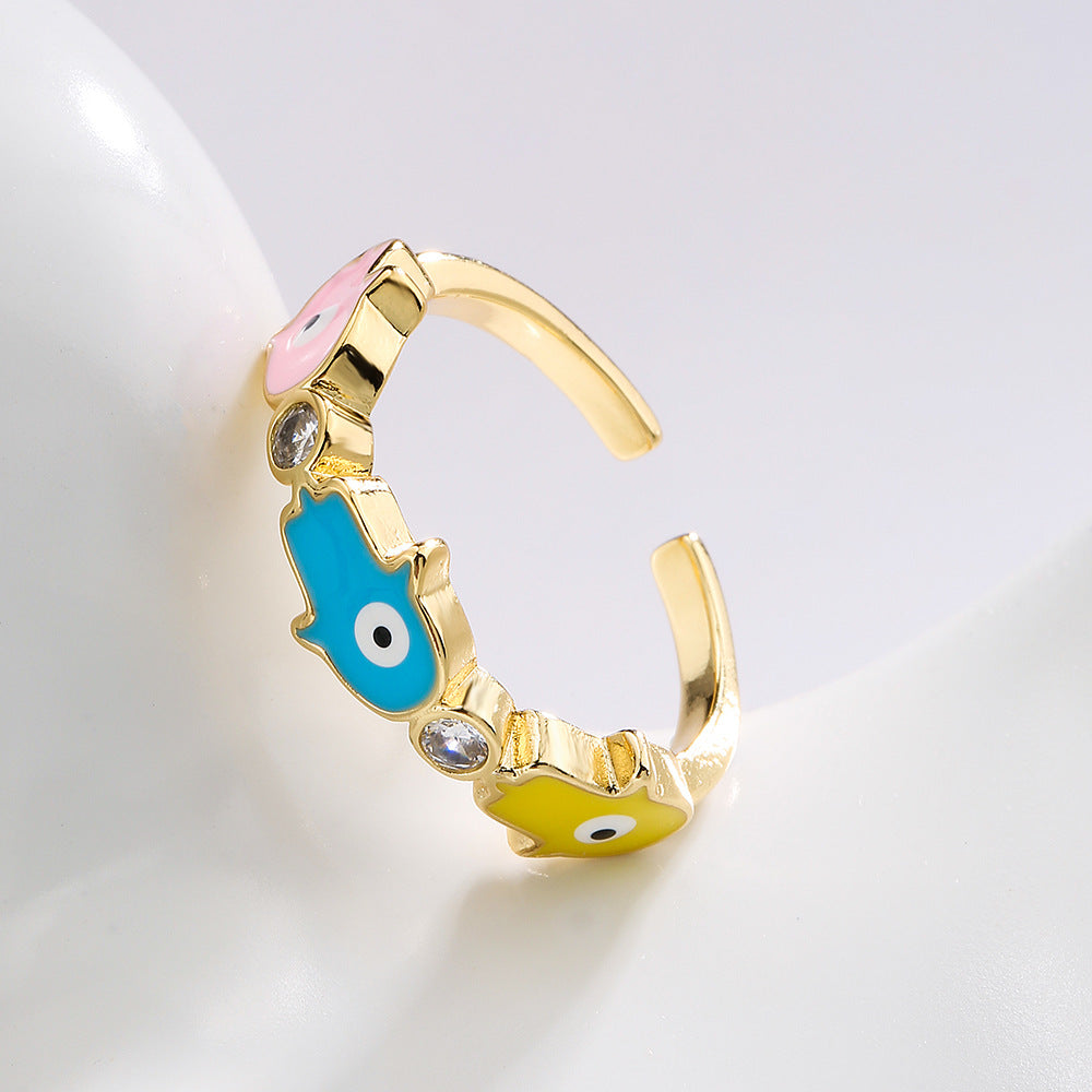 Anello da donna in rame con placca in oro 18K, finitura smaltata e intarsio in zircone, design Mano di Fatima