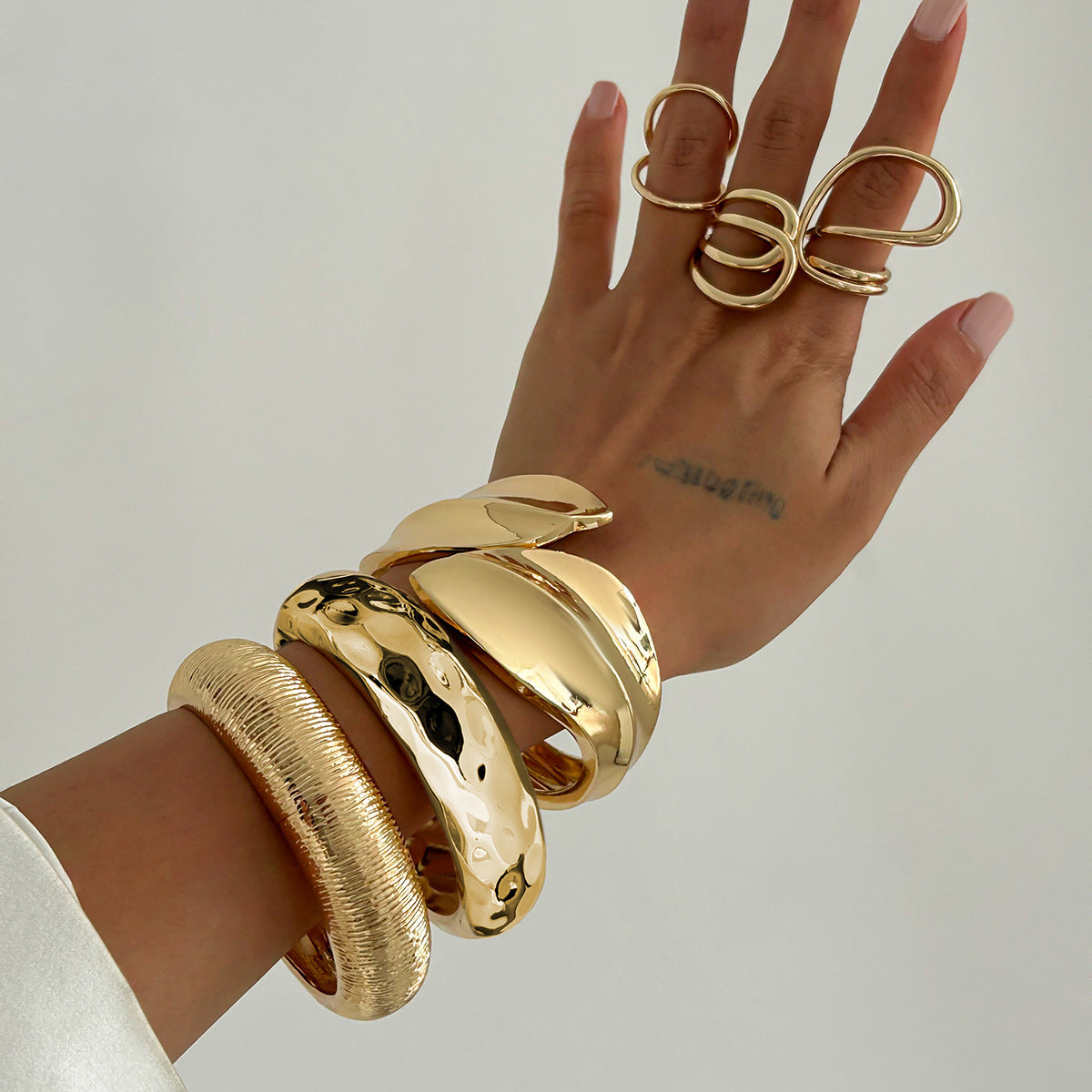 Bracciale irregolare in lega lucida a forma di foglia con bracciale aperto a strisce testurizzate