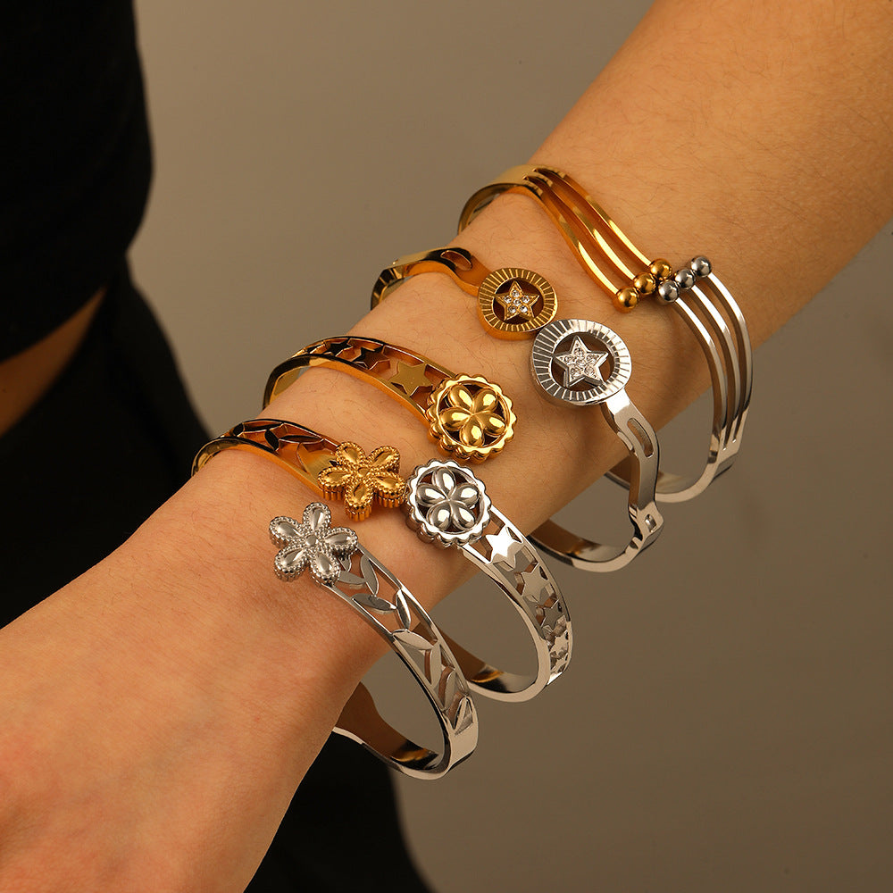 Minimalist Asymmetrical Stainless Steel Bracelet with Gold Plating Featuring Floral and Star Motifs and Linear Design