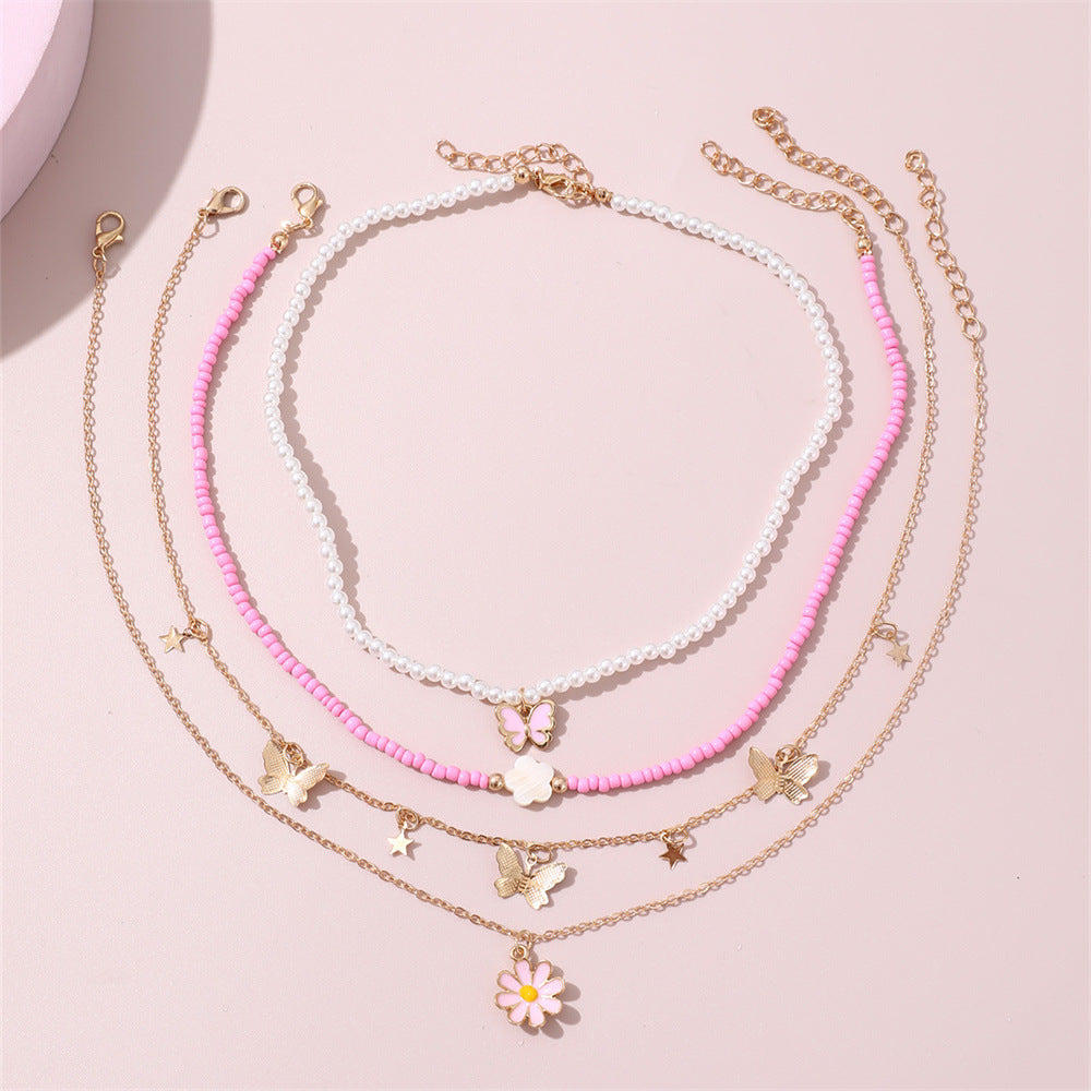 Set collana con pendente a farfalla rosa e floreale per bambini con perle in resina e ciondolo in lega, finitura smaltata, catena a sfere rotonde