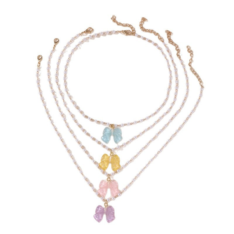 Conjunto de collar minimalista de lazo y corazón para niñas con colgante de resina en cadena de cuentas Colección de Verano
