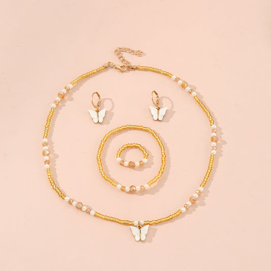Conjunto de collar con colgante de mariposa y corazón minimalista con acabado esmaltado para niños, pulsera y anillo de cuentas de vidrio, cadena de cuentas redondas