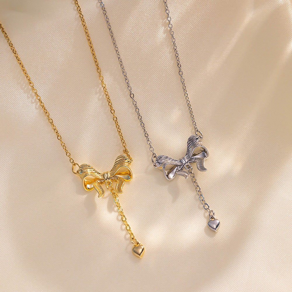 Minimalist Bowknot Tassel Heart Pendant Necklace in Titanium Steel with Vacuum Plating Snake Chain for Women