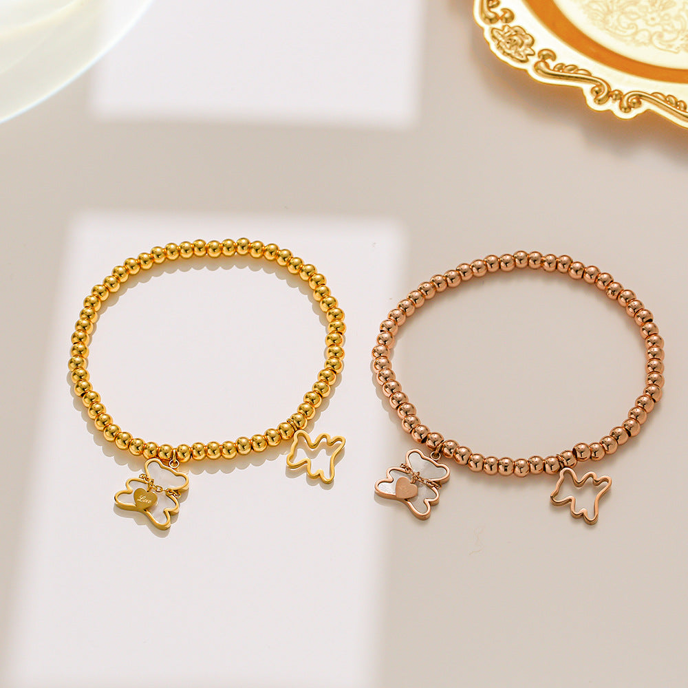 Bracciale Minimalista con Orsetto in Acciaio al Titanio, Perline, Intarsio in Madreperla e Placcatura in Oro per Donne