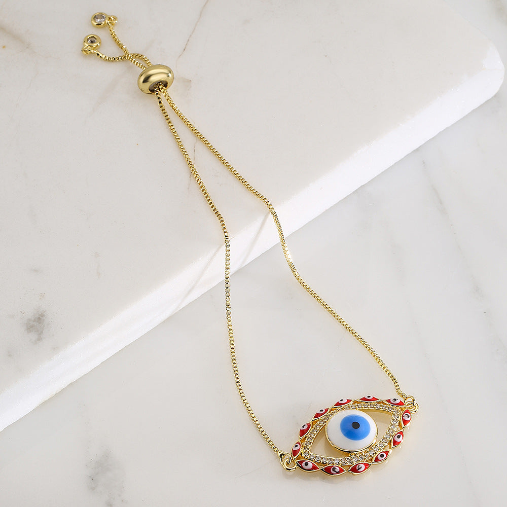 Bracciale da donna stile bohémien con charm a forma di occhio di Nazar, base in rame placcata in vero oro e intarsio di zirconi