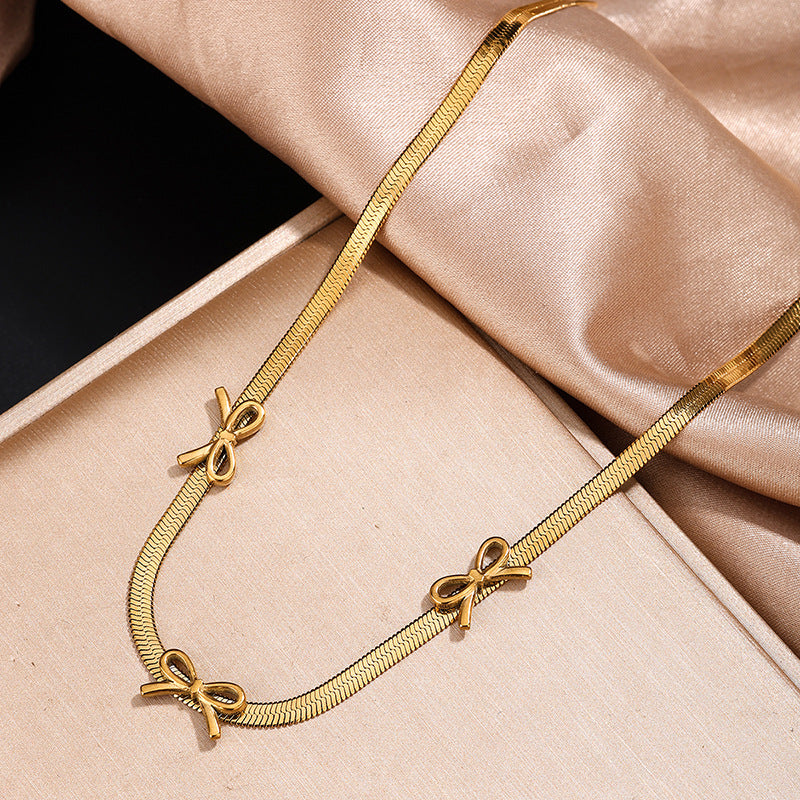 Parure collana e orecchini a fiocco da donna in acciaio inossidabile placcato oro 18 carati, stile minimalista