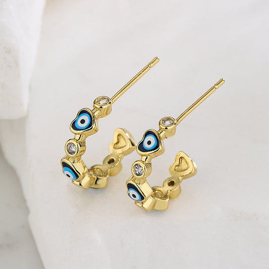 Pendientes de cobre estilo geométrico con baño de oro de 18K y diseño en forma de C con microincrustaciones de circonitas de corazón y ojo para mujer