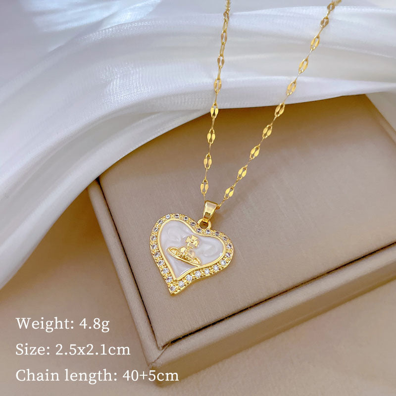 Collana con pendente a cuore e pianeta minimalista da donna e uomo con intarsio di zirconi su catena a serpente in acciaio al titanio