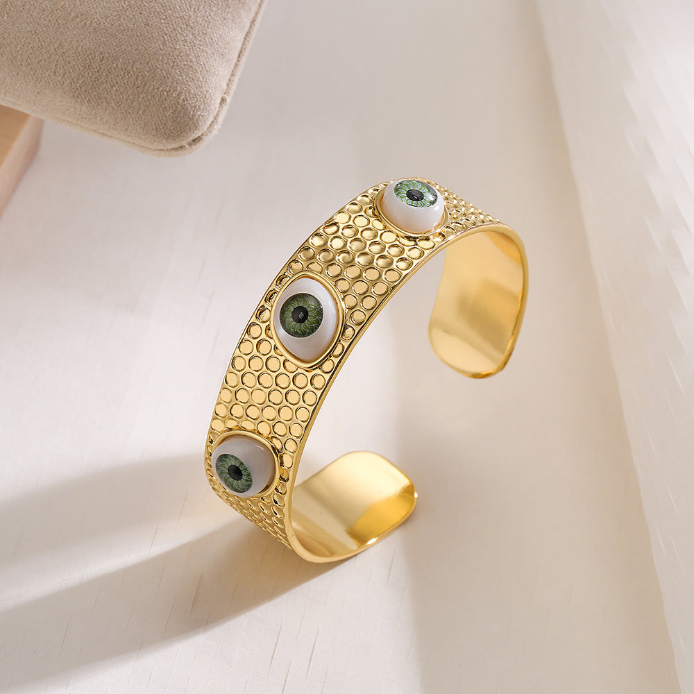 Bracciale rigido aperto geometrico da donna con base in rame e placcatura in oro 18 carati con design a occhio di Allah