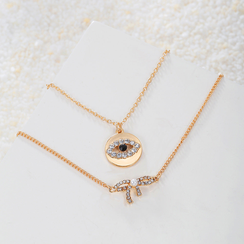 Sweet Rhinestone Inlaid Alloy Butterfly Evil Eye Bow Pendant Necklace with Curb Chain for Women