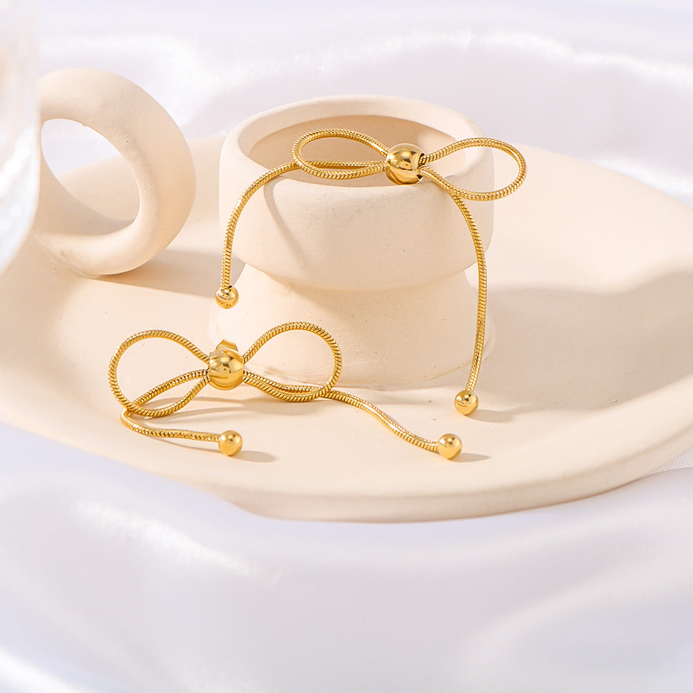 Minimalist Bow-Shaped Stainless Steel Earrings with Pull-Through Design and Tassel Details