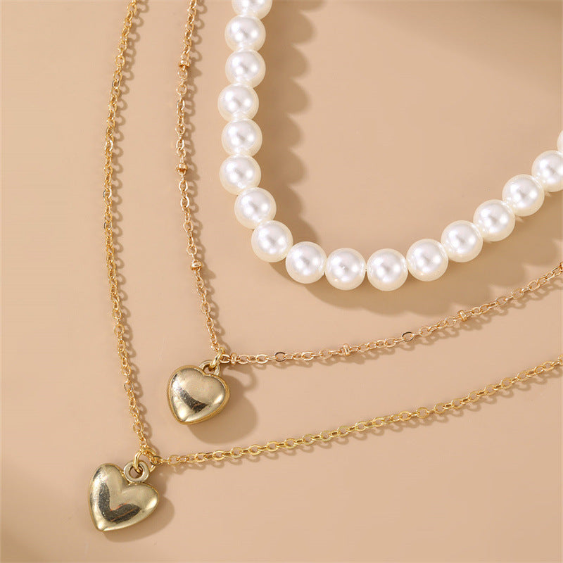 Collar infantil multicapa de inspiración vintage con moneda de perlas y colgante de corazón en cadena de caja para niñas