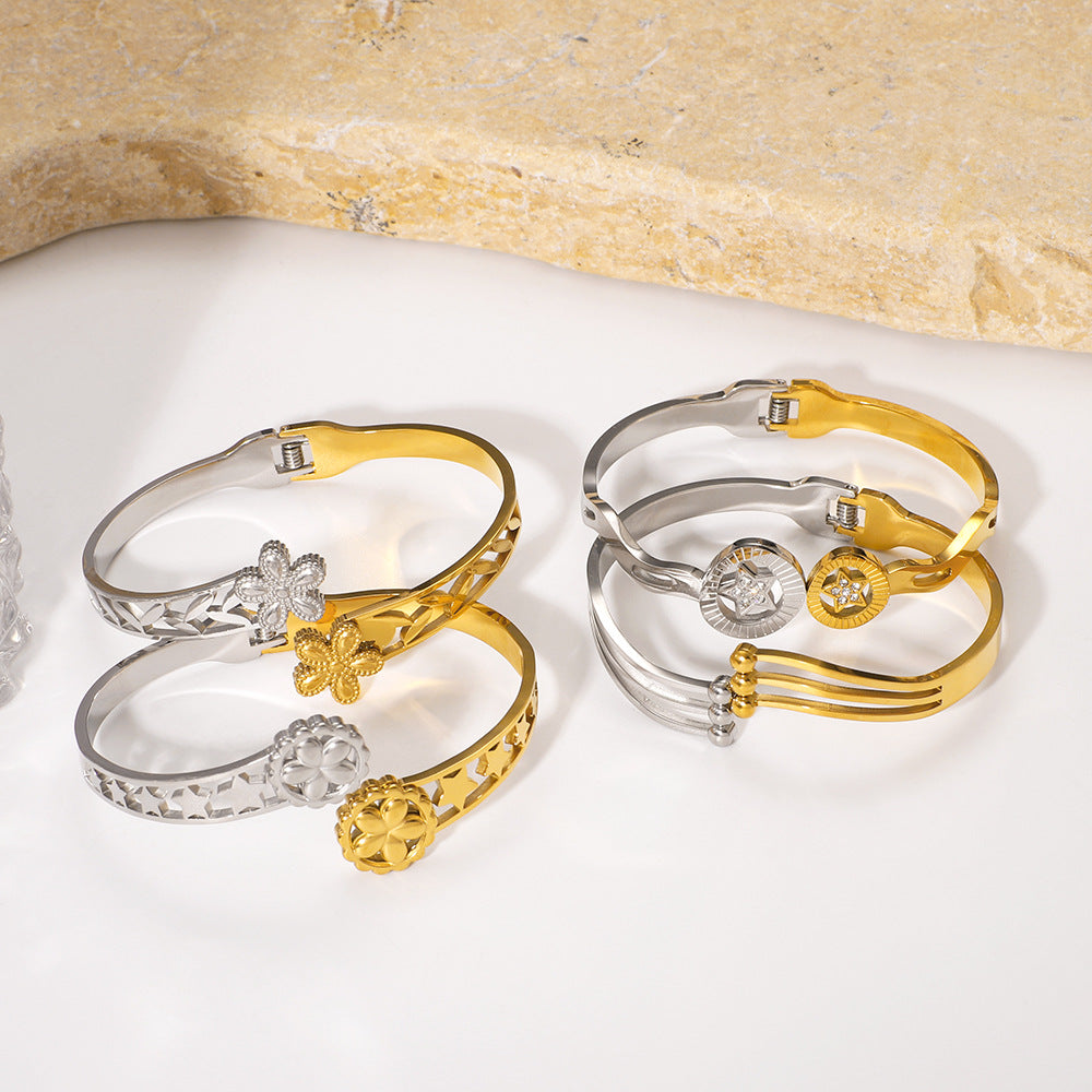 Minimalist Asymmetrical Stainless Steel Bracelet with Gold Plating Featuring Floral and Star Motifs and Linear Design