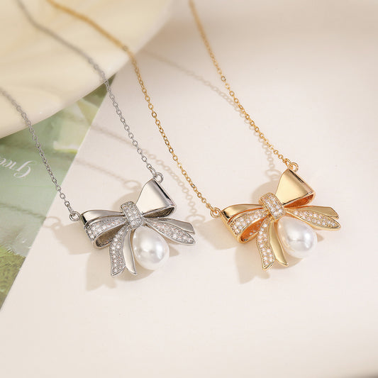 Sweet Bowknot Pendant Necklace for Women with Copper Base Plated in 18K Gold Featuring Zircon and Pearl Accents on Delicate Clavicle Chain