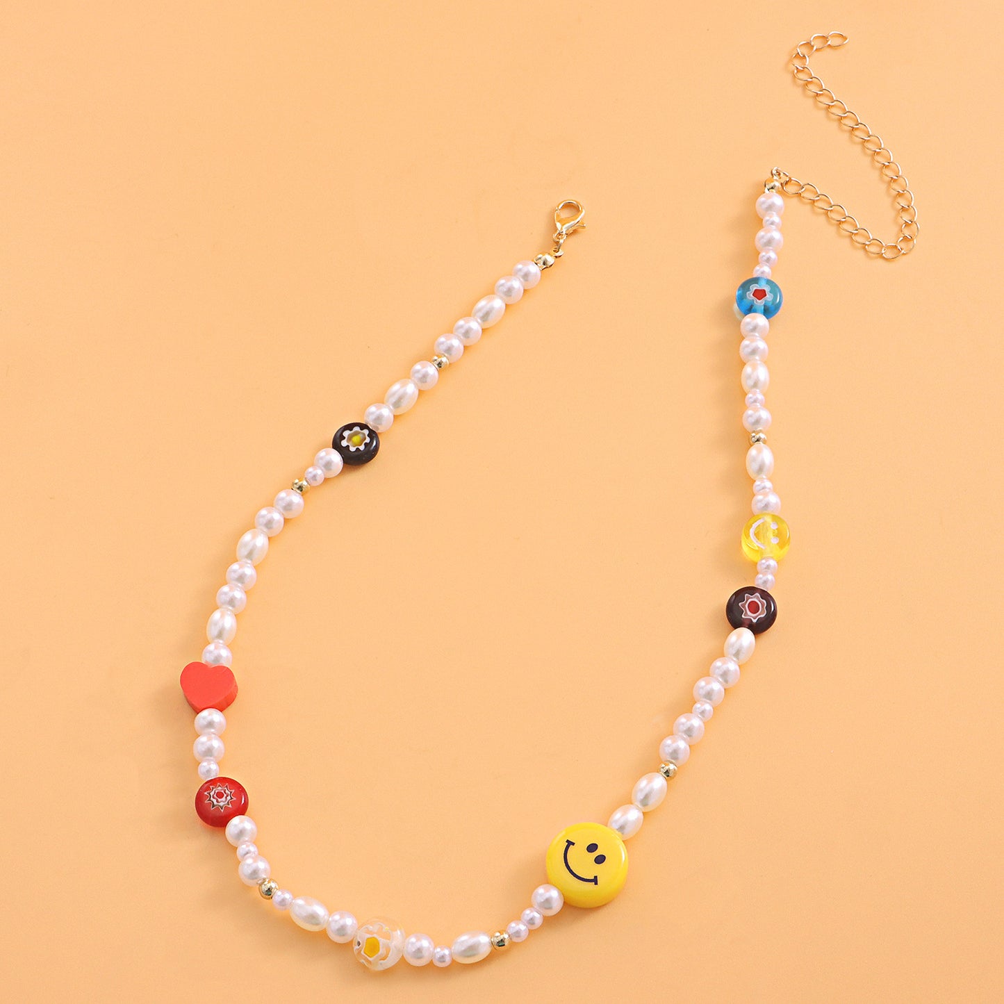 Yellow Smiley Face Acrylic Necklace with Red Heart-Shaped Polymer Clay and Glass Flower Pendant on Clear Fishing Line Chain