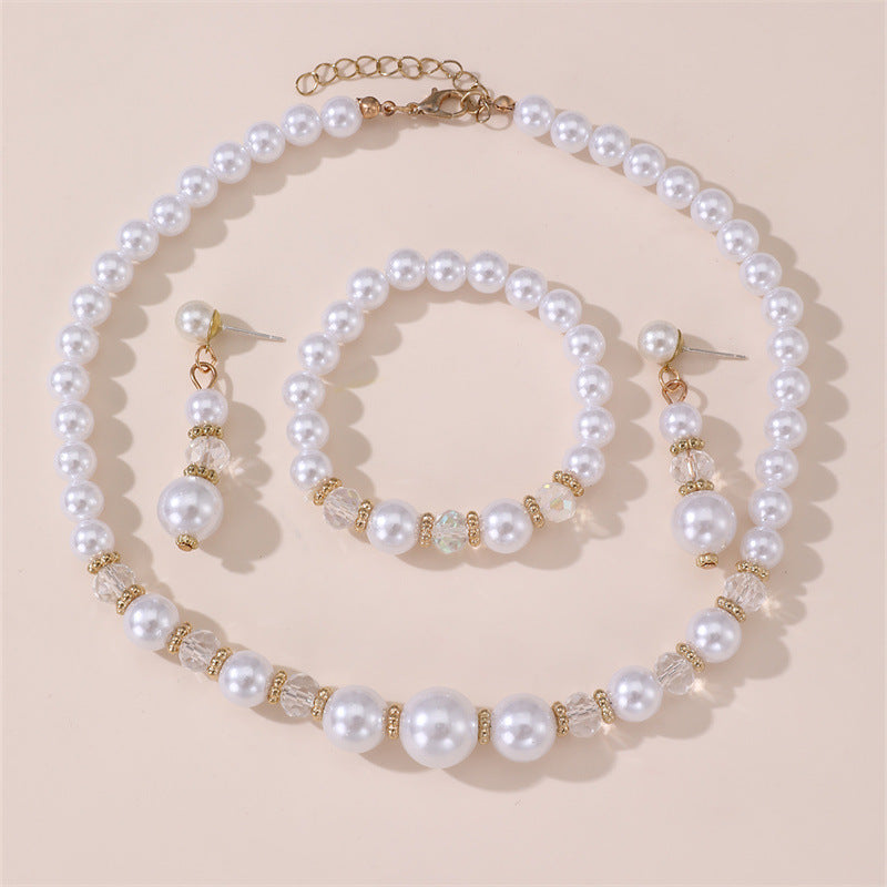 Conjunto de collar, aretes y pulsera minimalistas con perlas y lazo para niñas