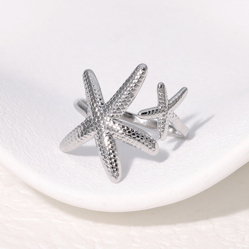 Elegante anello regolabile da donna in acciaio inossidabile a forma di stella marina con finitura placcata, gioiello da spiaggia ispirato all'oceano