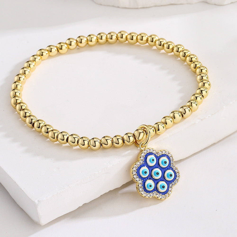 Bracciale geometrico in rame stile INS con placcatura in oro 18K, intarsio di strass e dettaglio occhio blu smaltato