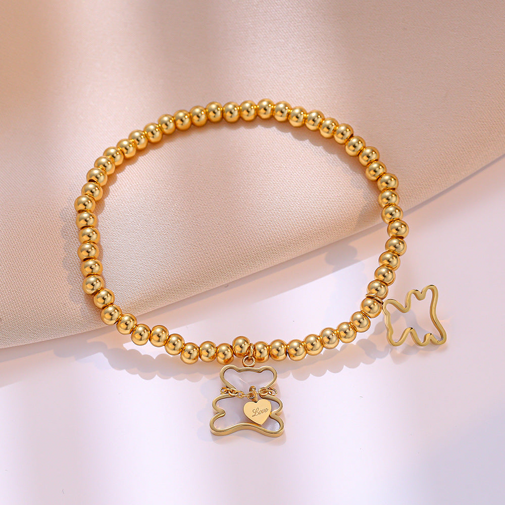 Bracciale Minimalista con Orsetto in Acciaio al Titanio, Perline, Intarsio in Madreperla e Placcatura in Oro per Donne