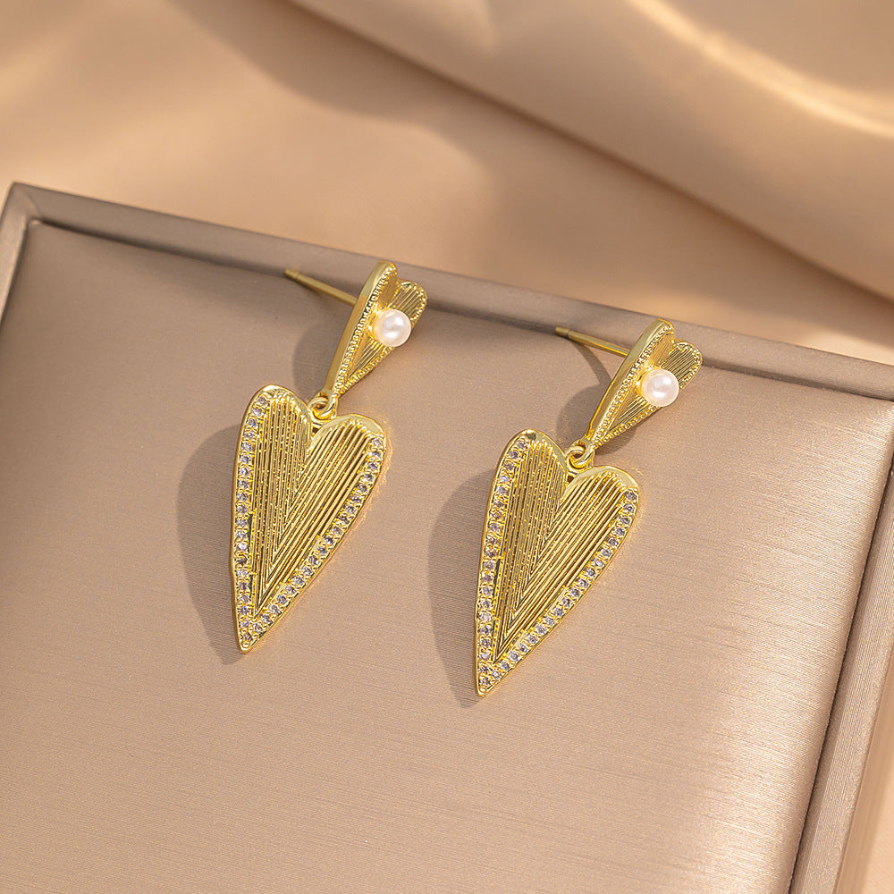 Orecchini a perno minimalisti e moderni a forma di cuore in acciaio al titanio con placcatura in oro vero e accento di perla ipoallergenica