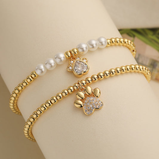 Pulsera de Cobre con Colgante de Huella de Perro de Circonita Cúbica Microengastada y Chapado en Oro de 18K para Mujer