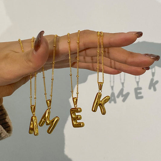 Collar con colgante de letra geométrica minimalista en acero inoxidable con dije de acero de titanio y acabado chapado para mujer