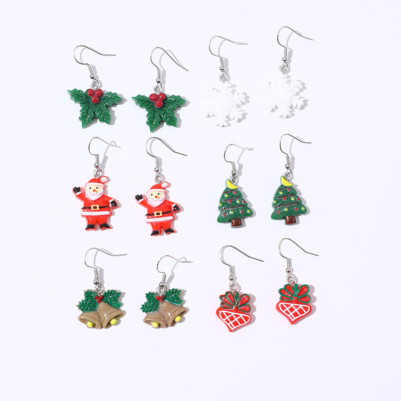 Set de pendientes infantiles con temática navideña con copo de nieve, cascabel y colgante de árbol de Navidad en material de resina