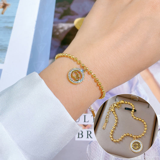 Bracciale da donna in stile retrò minimalista a doppio anello a cuore in acciaio al titanio con placcatura in oro e trama ondulata