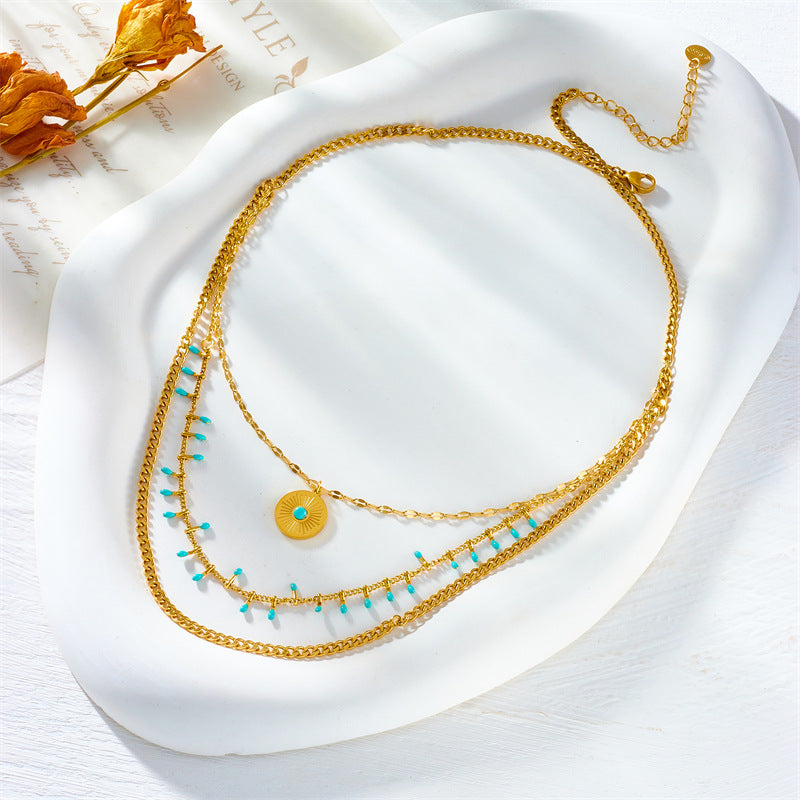 Collana da donna vintage in stile etnico con ciondolo rotondo turchese in acciaio al titanio con finitura placcata