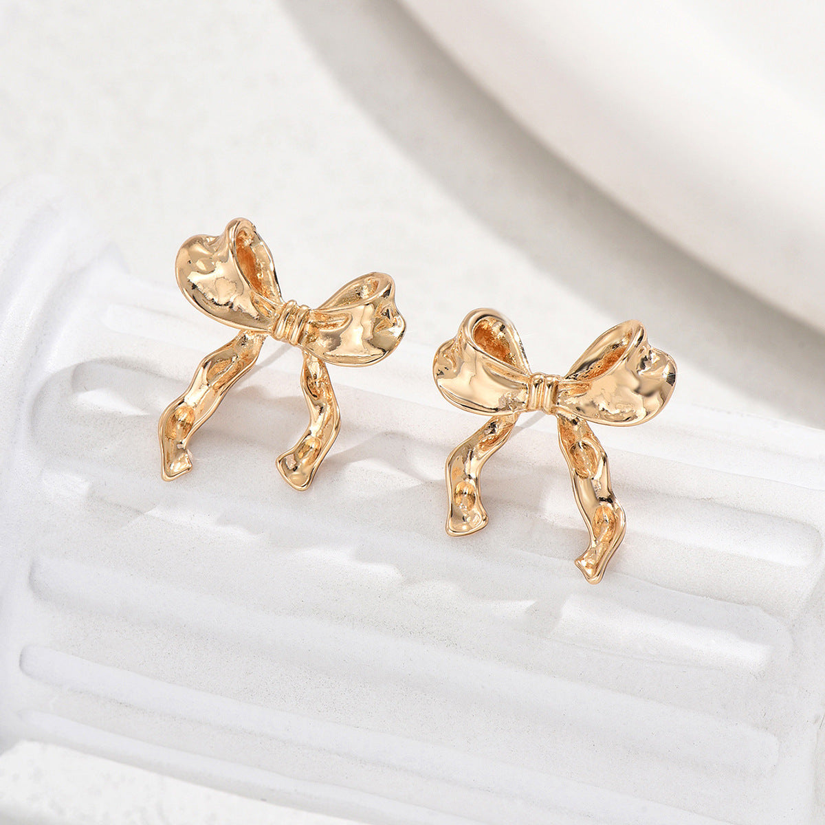 Pendientes de tuerca minimalistas de aleación con forma de lazo para mujer con acabado galvanizado, estilo de lujo ligero, para oficina