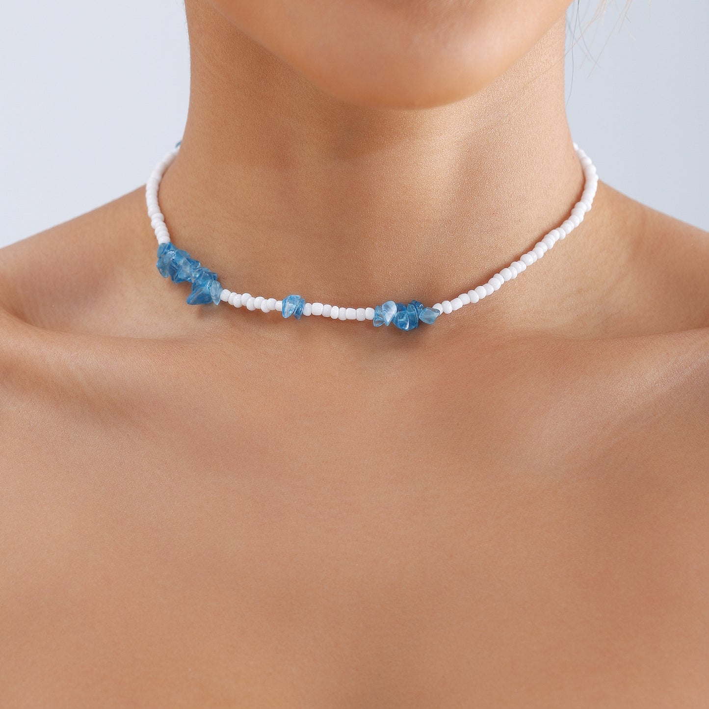 Bohemian Geometric Beaded Necklace for Women with White Beads and Blue Crystal-Like Accents on Clavicle Chain