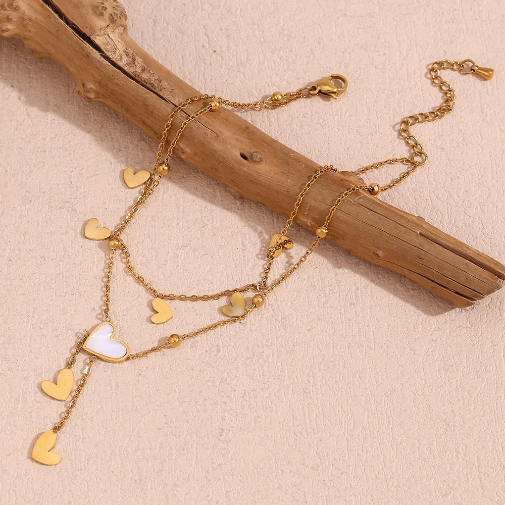 Tobillera Minimalista de Doble Capa con Cadena de Acero Inoxidable, Cuentas Espaciadoras en Forma de Corazón Bañadas en Oro de 18K, Abalone Blanco y Detalles de Borla