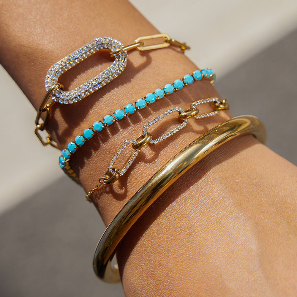 Pulsera geométrica de acero inoxidable chapado con circonita blanca y turquesa para mujer. Joyería minimalista de lujo.
