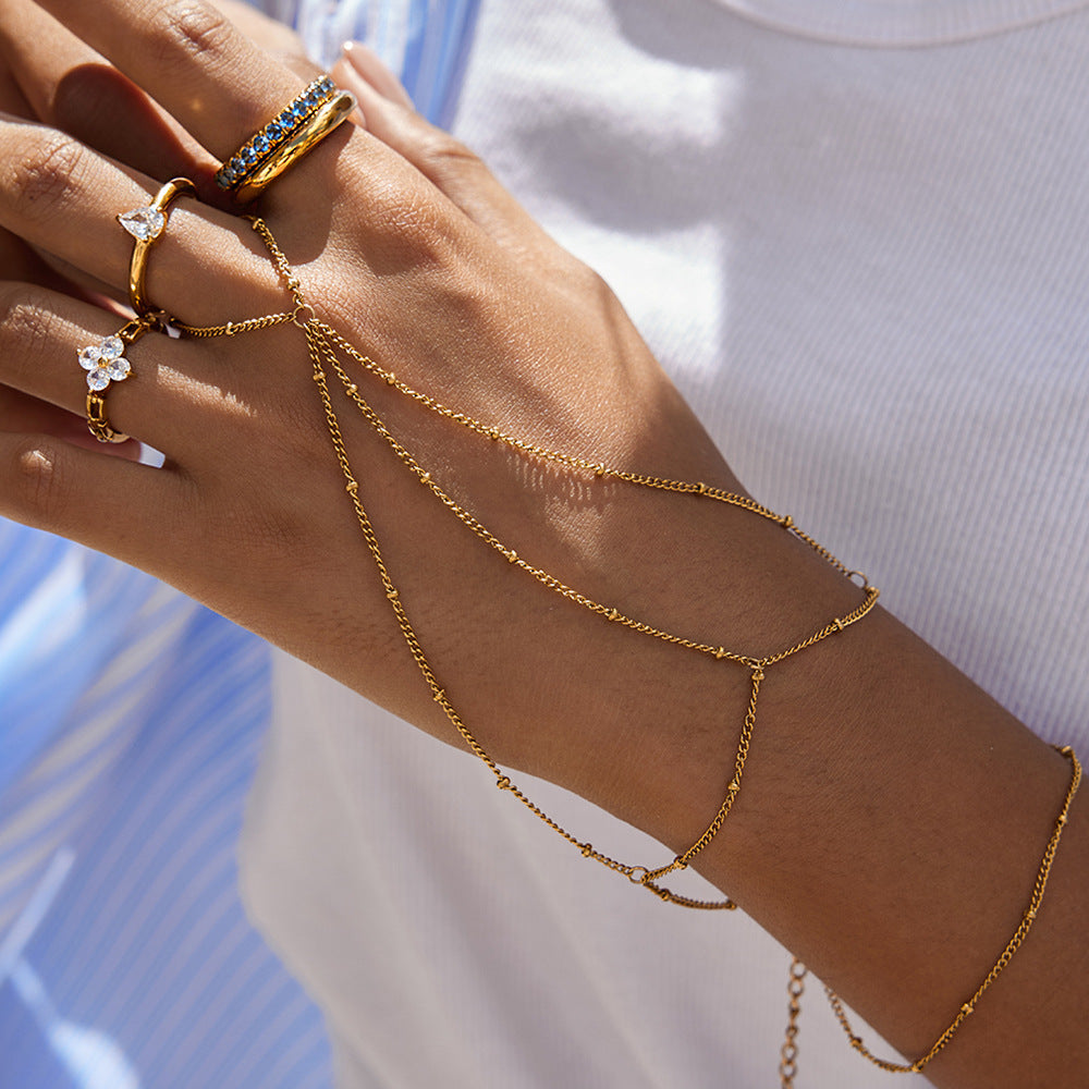 Pulsera de dedo de doble capa con borla geométrica de acero inoxidable y abalorios con acabado chapado para mujer