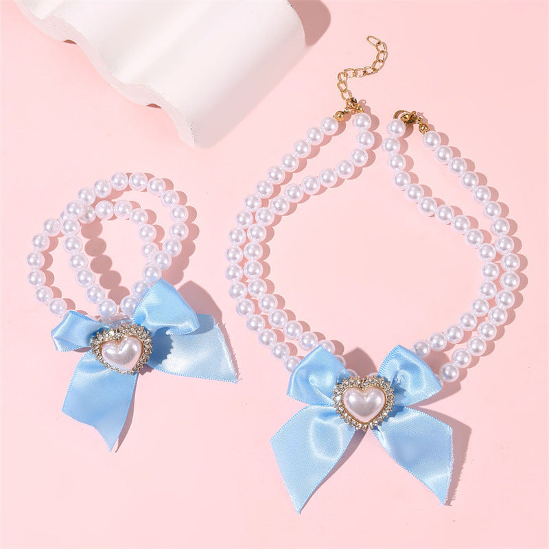 Elegante collar de perlas de doble capa para niñas con lazo y colgante de corazón en estilo estético crema, joyería de resina