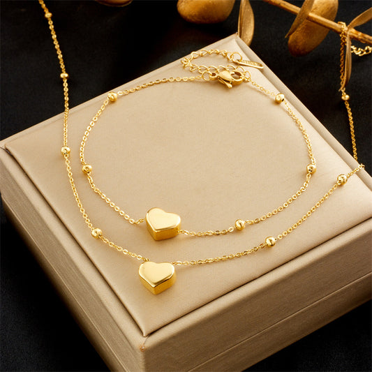 Set collana e bracciale da donna in acciaio al titanio a forma di cuore, stile minimalista, con finitura placcata