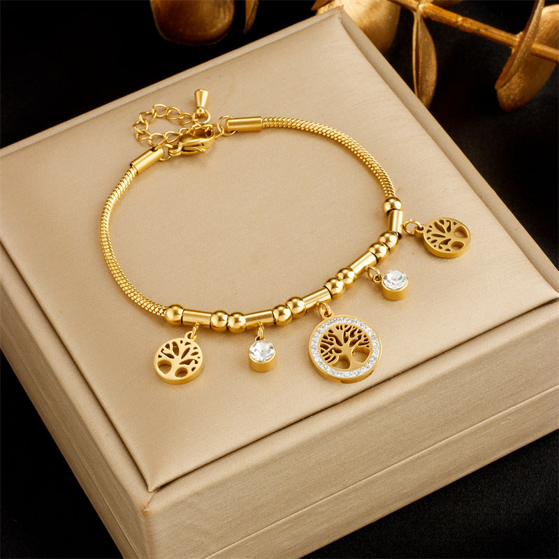 Braccialetto da donna con ciondolo albero della vita traforato in acciaio inossidabile, ispirato al vintage, con intarsi di strass e finitura placcata
