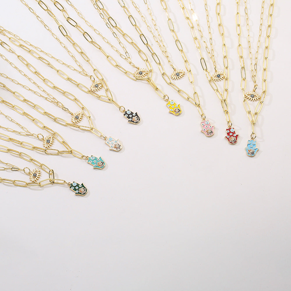 Collana con ciondolo minimalista a mano e occhio per donna in rame con finitura smaltata e intarsi in strass su catena placcata oro 18 carati