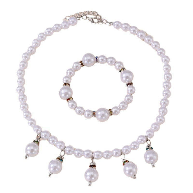 Conjunto de collar, aretes y pulsera minimalistas con perlas y lazo para niñas