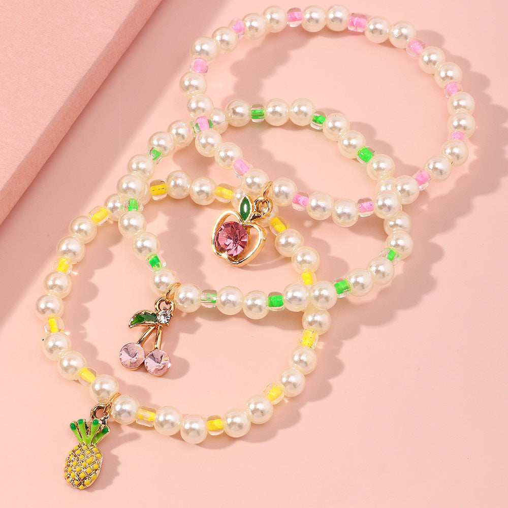 Juego de pulseras infantiles con forma de fruta estilo caricatura, con detalles de perlas y base de aleación para niñas de 6 a 10 años