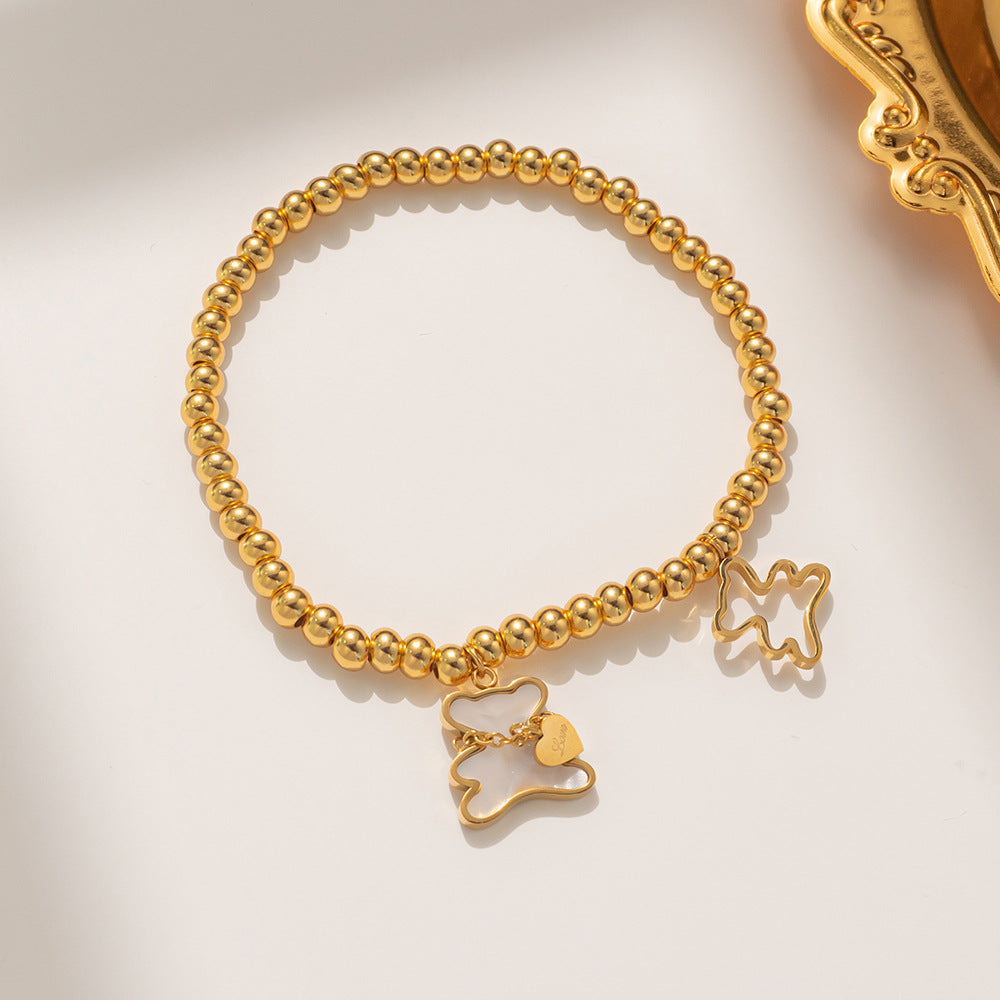 Bracciale Minimalista con Orsetto in Acciaio al Titanio, Perline, Intarsio in Madreperla e Placcatura in Oro per Donne