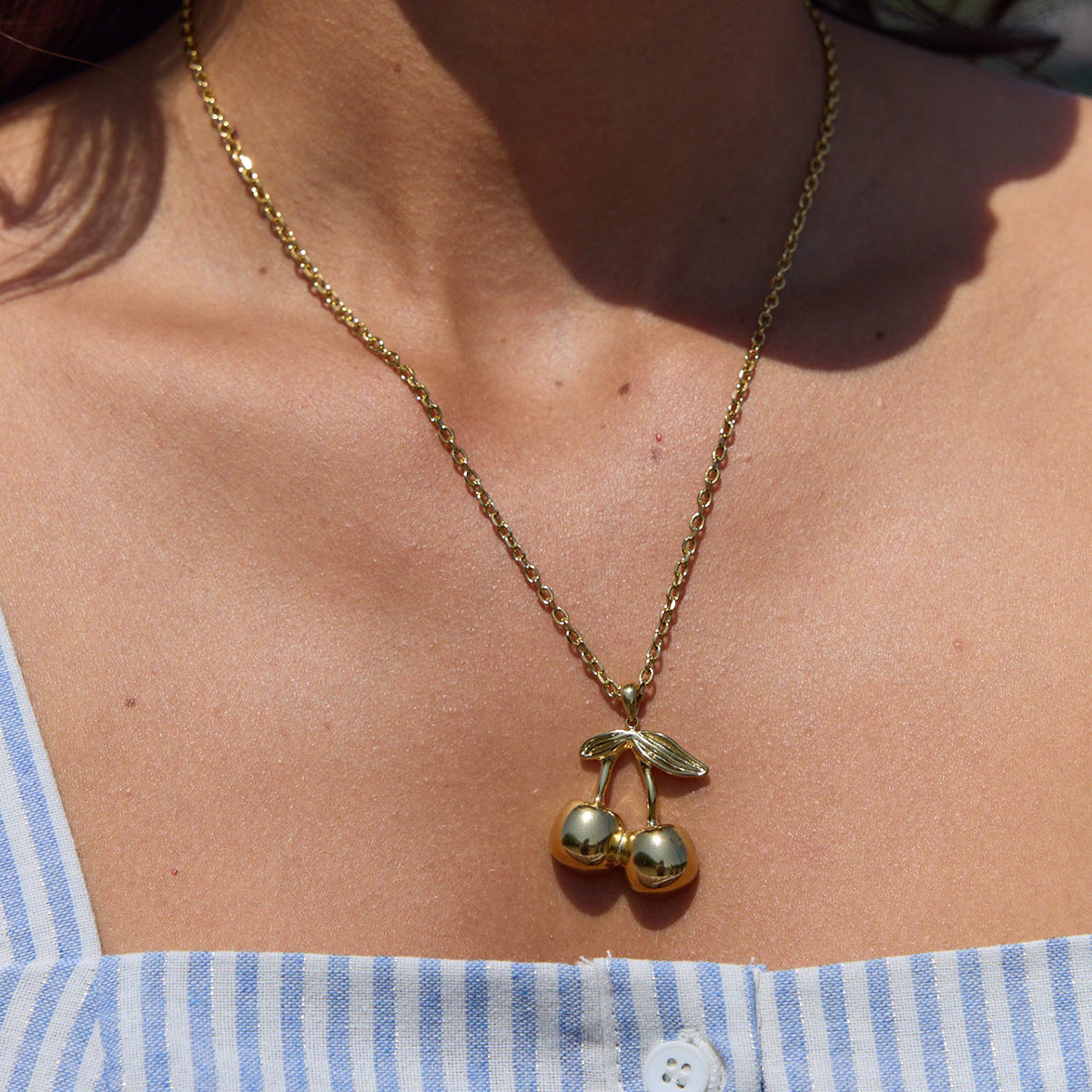 Collana da donna con ciondolo geometrico a ciliegia in acciaio al titanio placcato oro 18 carati